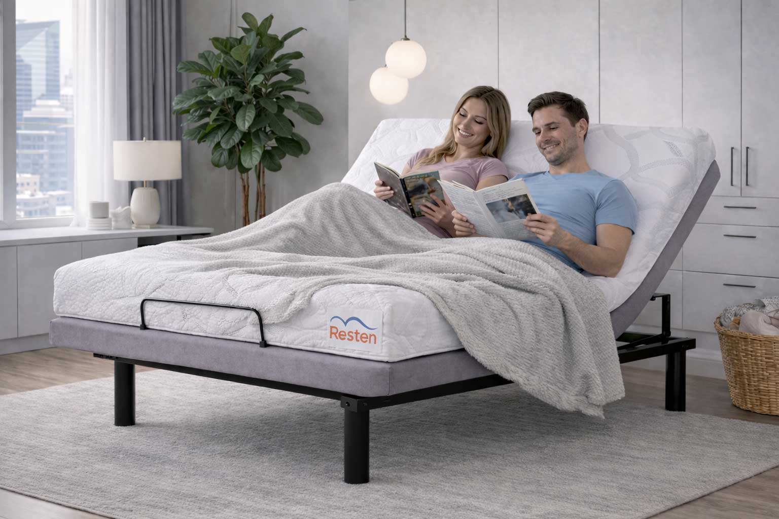 Man and woman laying on a Resten Select bed while reading books with the headrest up
